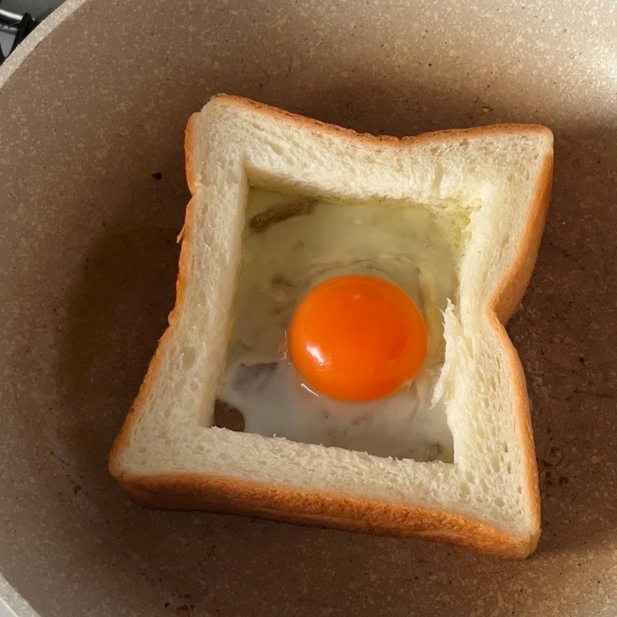 食パンの枠の部分を焼き、真ん中に
卵、トマト、ハム、チーズの順に重ね
最後に食パンのくり抜いた部分をのせる